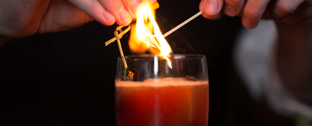 Lighting flame above drink