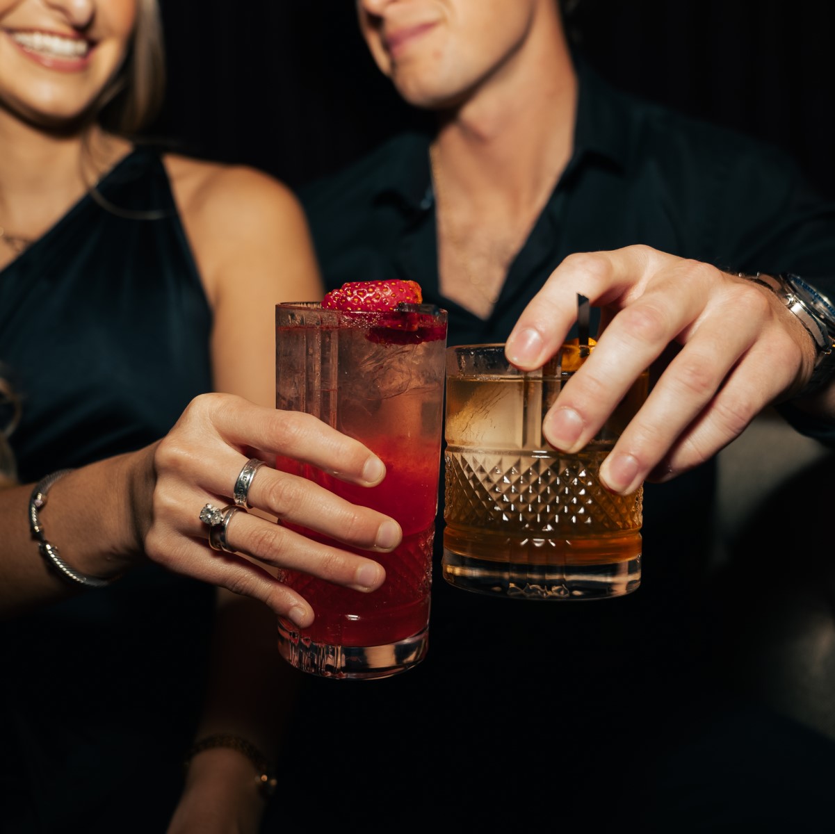 Couple toasting cocktails on an evening date.