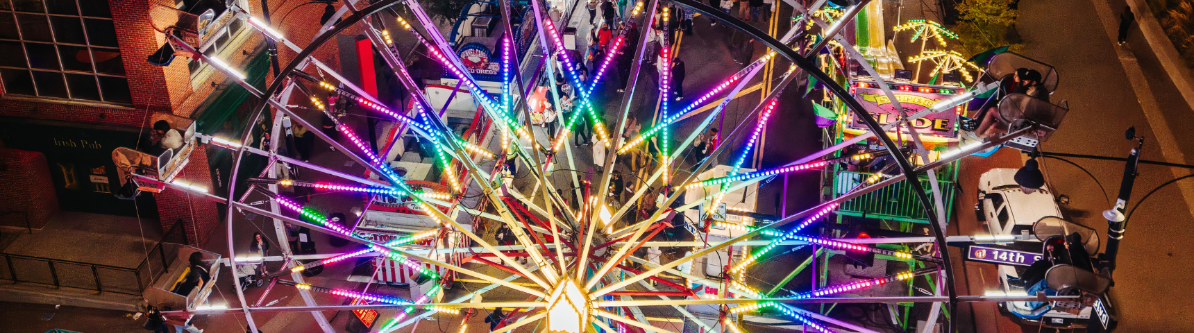 Ferris wheel lit up at night at Cornucopia fall festival at Kansas City Power and Light District.