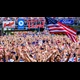 An excited crowd waves their arms and screams, with an American flag waving in the foreground and neon logos for Live! Ford, KC2026.com, and Leinenhugel's in the background.