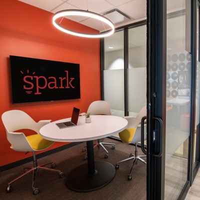 Spark coworking Kansas City small meeting room with digital display and round table